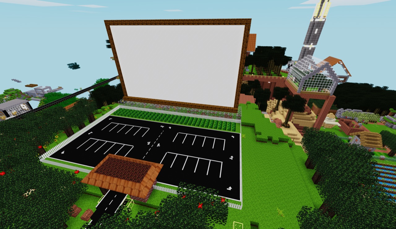 Drive-in movie screen overlooking a parking lot